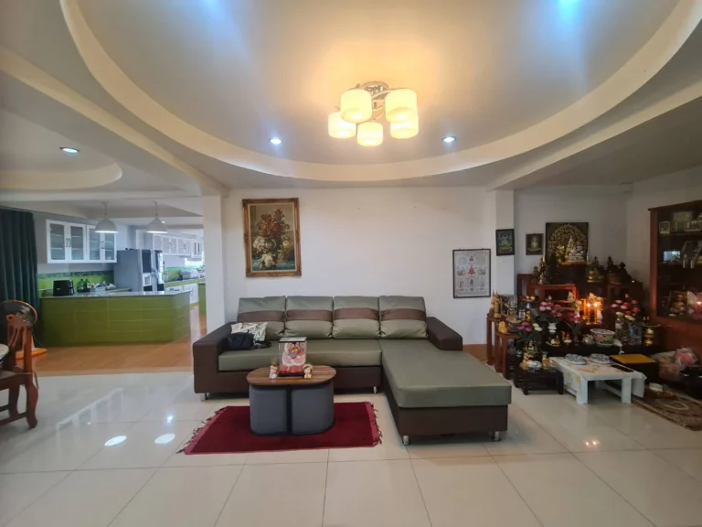 Living room under a round drop ceiling with glossy white tiles