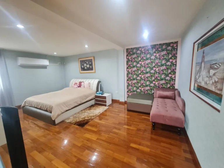Wood-floored master bedroom with air conditioning