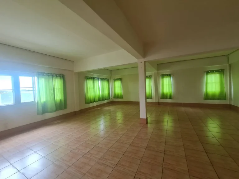 Open top-floor hall with windows on every side