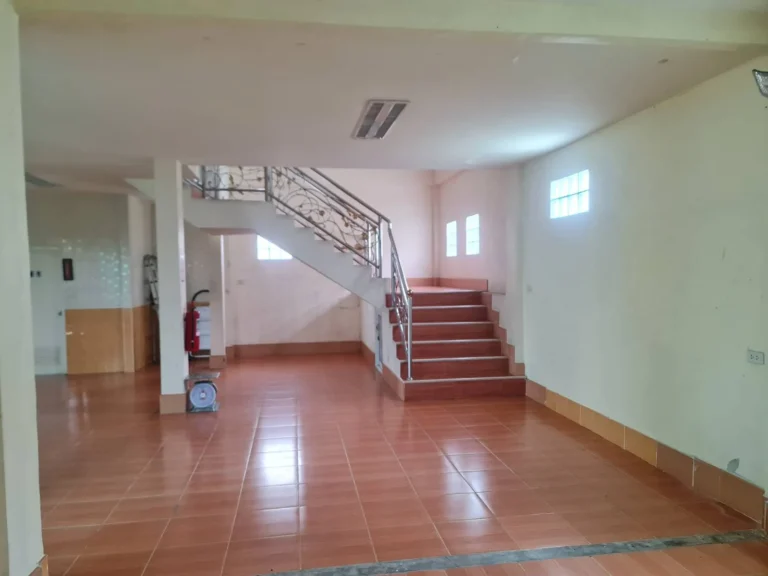 Ground-floor hall and a staircase with stainless-steel railings