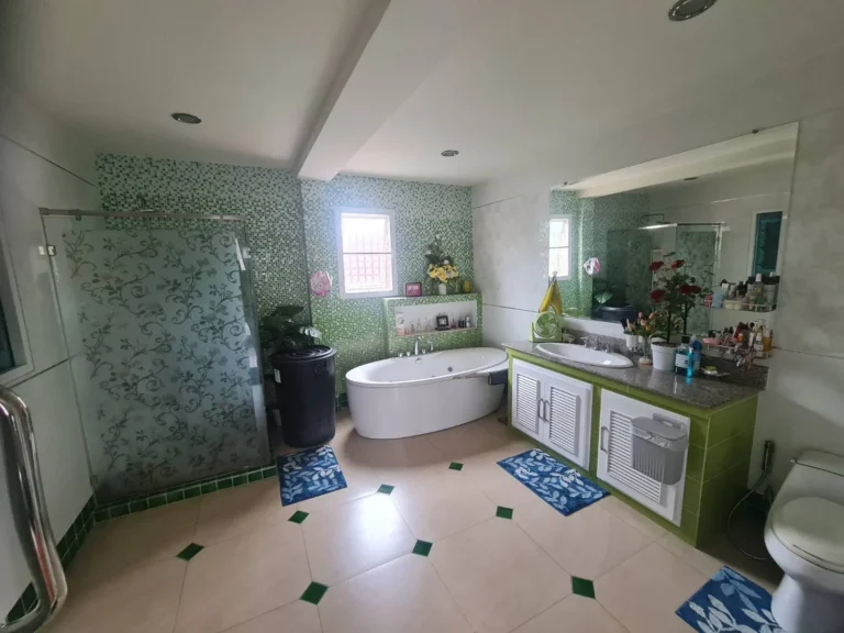 Large bathroom with an oval bathtub and a separate glass shower