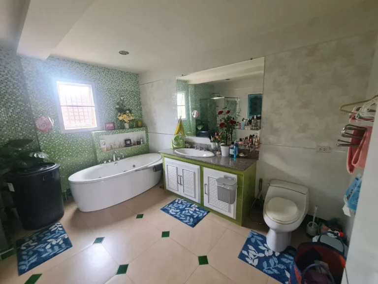 Another view of the large bathroom: oval bathtub and vanity counter
