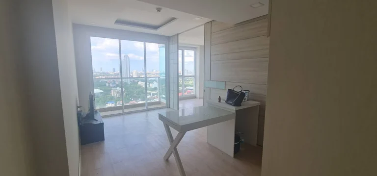 Living room with floor-to-ceiling windows and city views