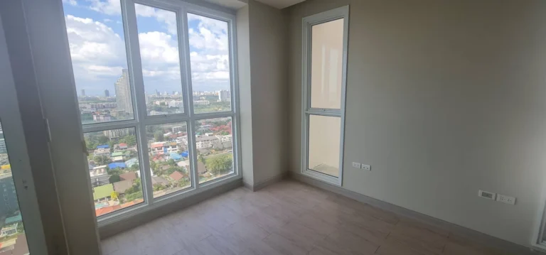 Bedroom with floor-to-ceiling windows, city views and plenty of natural light