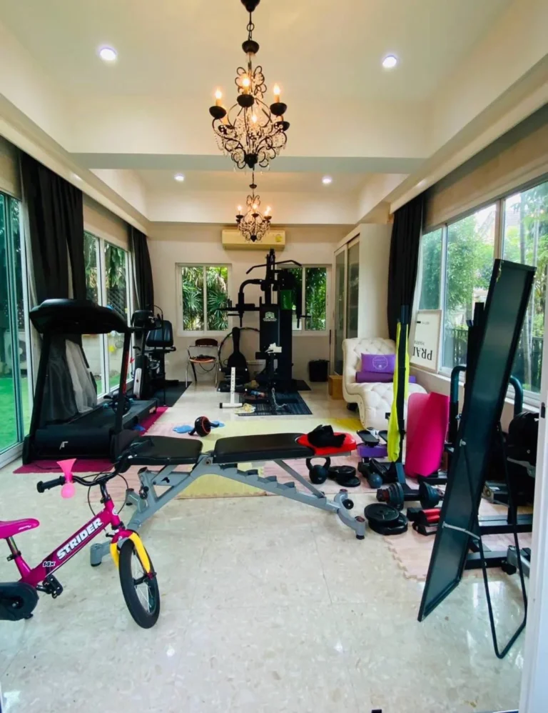 Fitness room with large windows in the glass room at the front of the house
