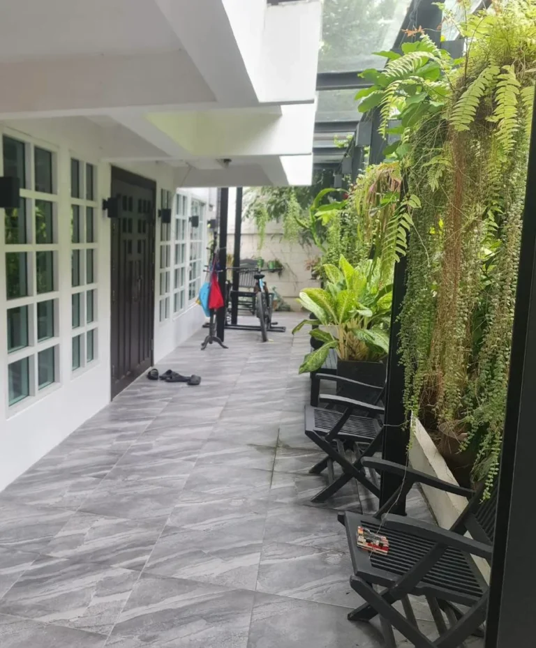 Covered side terrace beside the garden with tropical plants