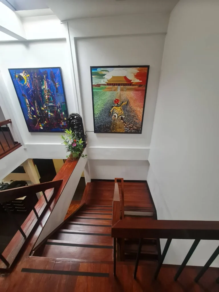 Double-height entrance hall with an open wooden staircase and a skylight