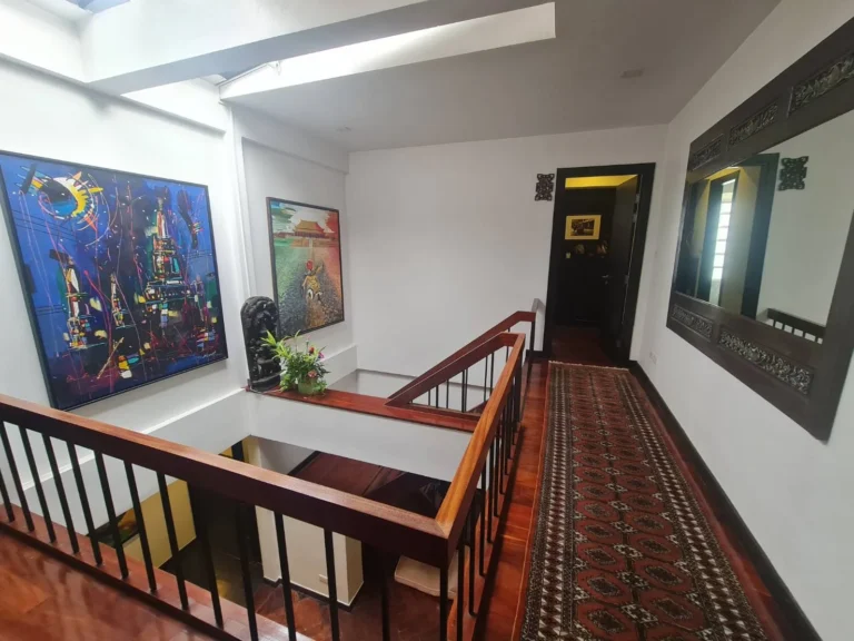Upstairs gallery landing with skylights and art walls