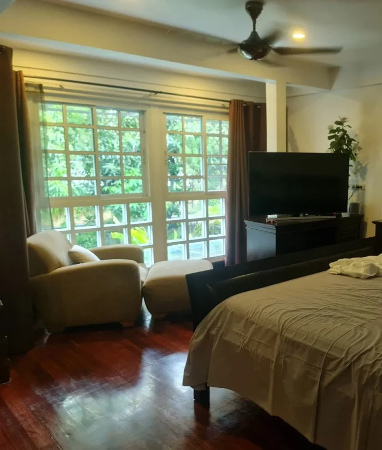Master bedroom with windows onto the garden