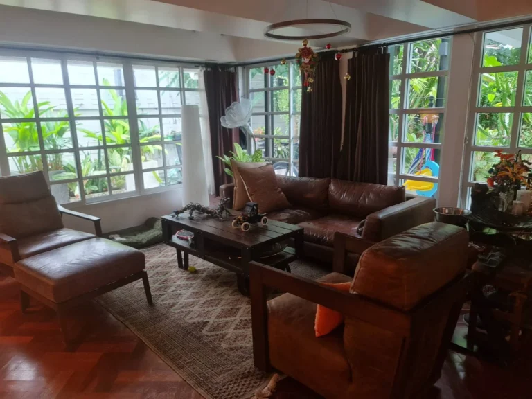 Living room with large grid windows onto the garden