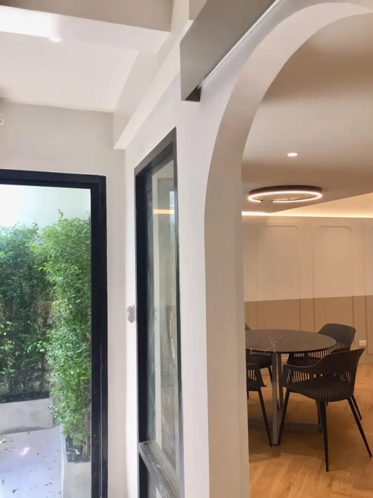 Arched doorway to the dining area and a glass door to the side garden
