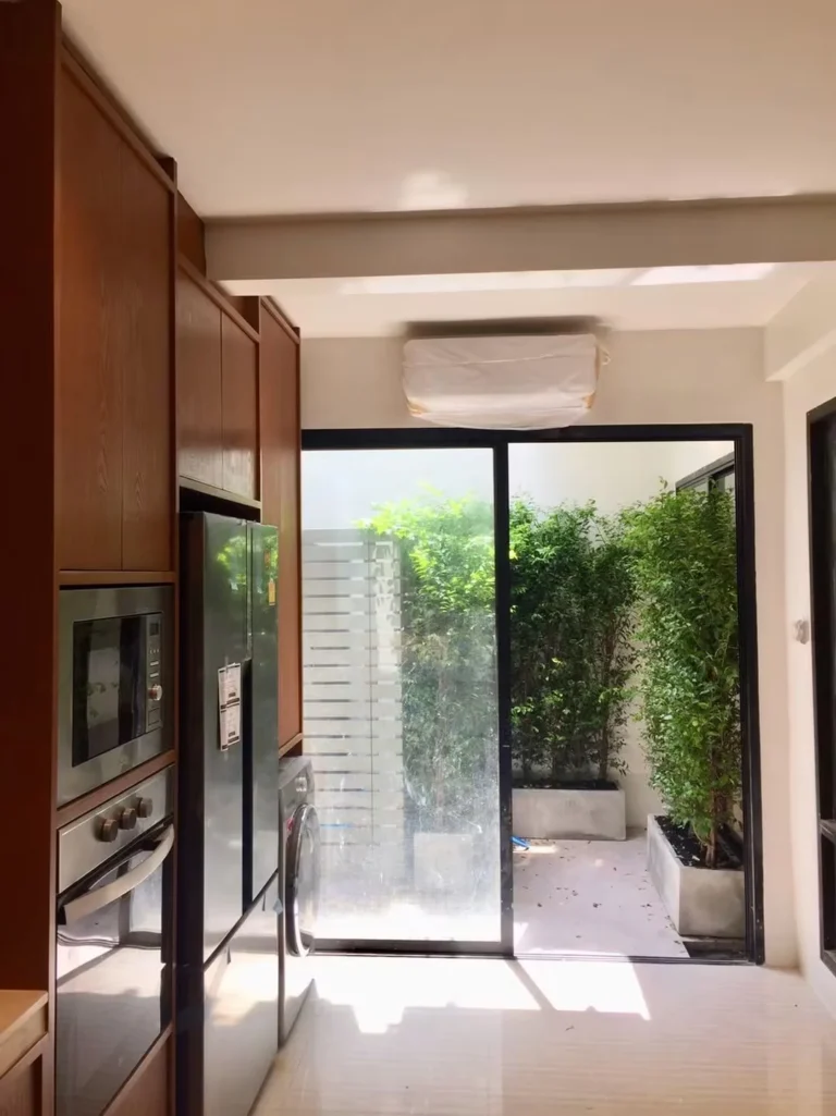 Air-conditioned kitchen with a sliding glass door to the back garden