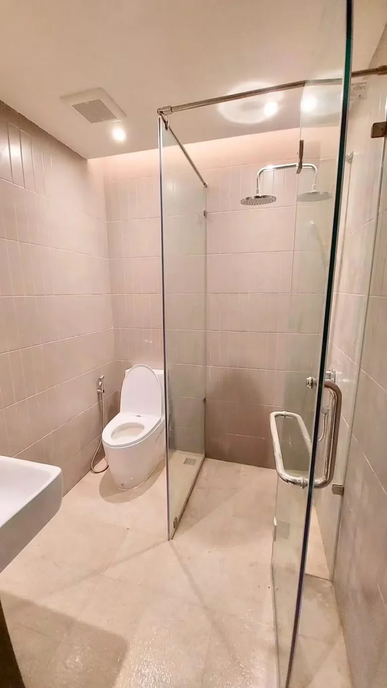 Bathroom with a glass-screened shower and a rain shower head