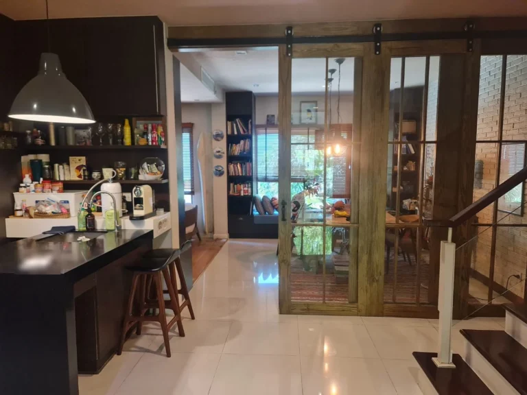Pantry with a bar counter and the dining room behind wooden sliding doors