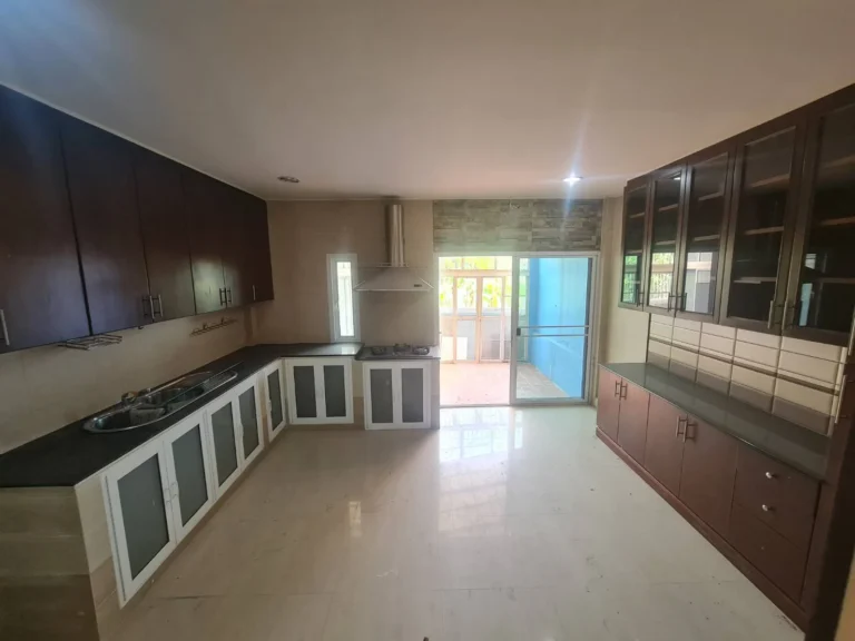 Large kitchen with built-in cabinets all round