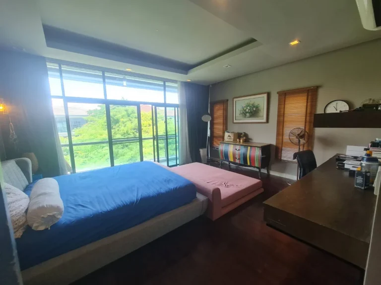 Master bedroom with floor-to-ceiling glass
