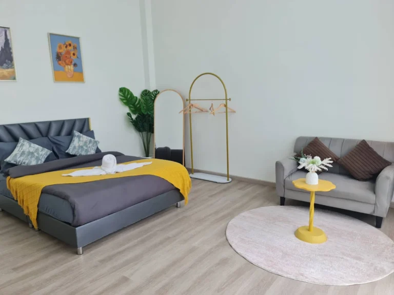 Bedroom with a king bed and a sofa corner