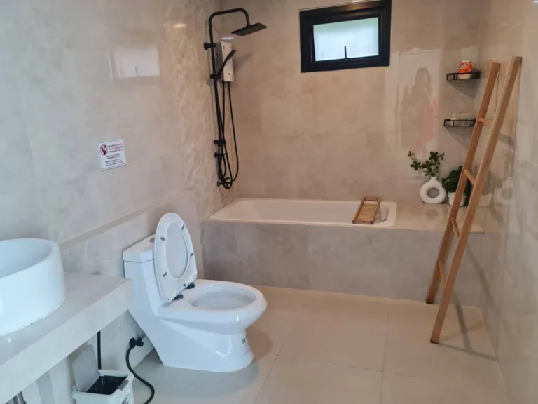 Bathroom with a bathtub and rain shower
