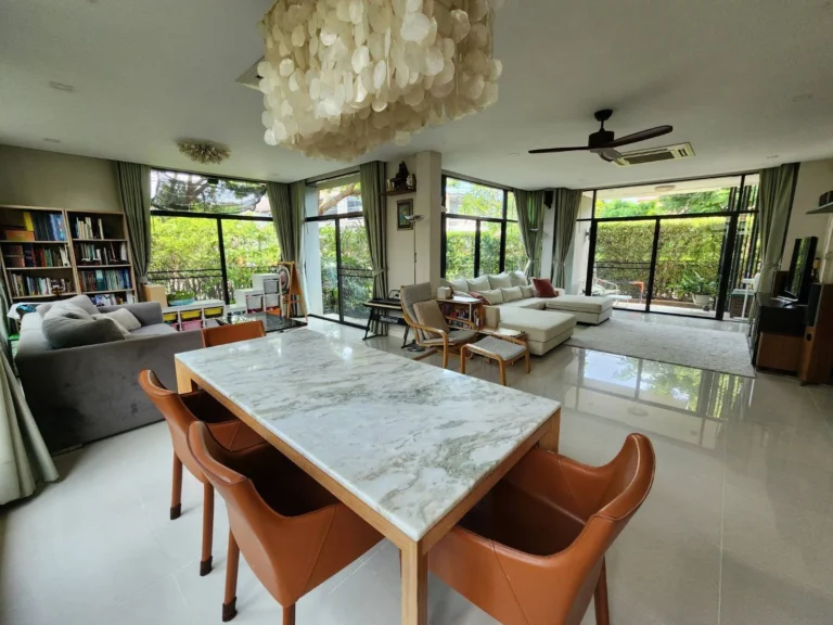 Marble dining table under a capiz shell chandelier